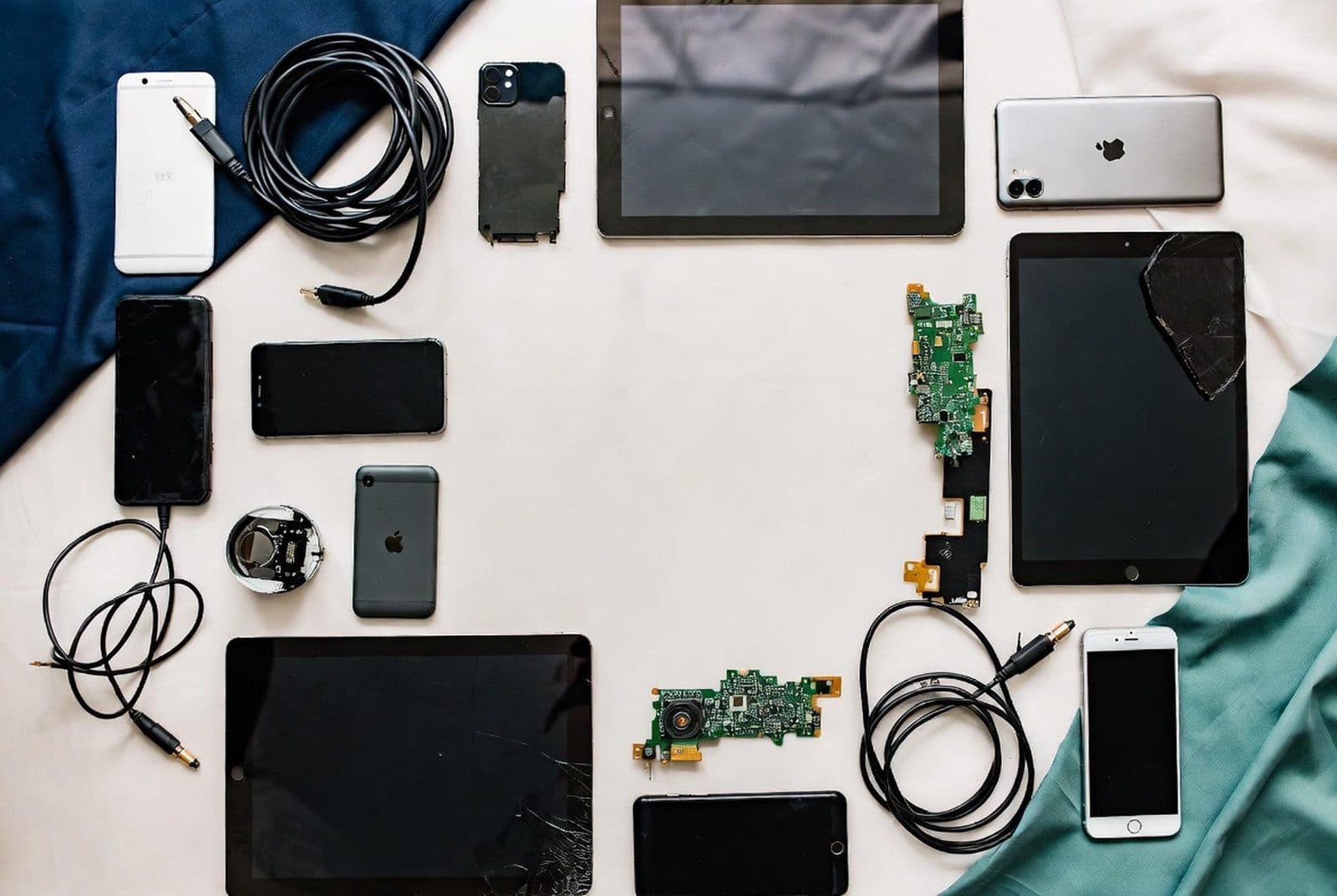 Retired phones, tablets, laptops and circuit boards laid out for sorting and grading